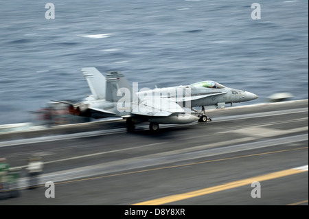 A US Marine Corps F/A-18C Hornet fighter aircraft launches from the flight deck of the aircraft carrier USS Nimitz June 3, 2013 operating in the Indian Ocean. Nimitz Strike Group is deployed to the U.S. 7th Fleet area of responsibility conducting maritime security operations and theater security cooperation efforts. Stock Photo