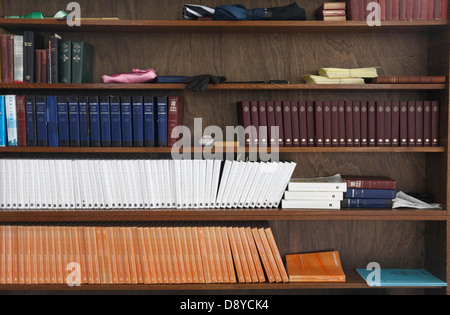 Prayer books and Bibles on a bookshelf inside a church, St. Mary's, Heacham, Norfolk, England.. Stock Photo