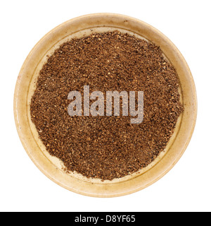 organic noni fruit powder from Hawaiian evergreen shrub in a small ceramic bowl, isolated on white, top view, Stock Photo