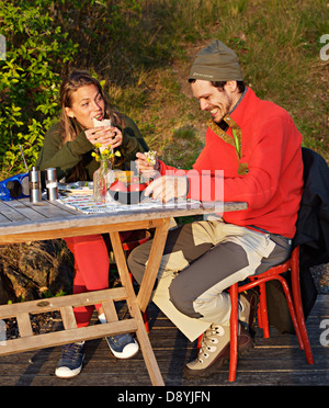 A man and a woman having dinner outdoors, Sweden. Stock Photo