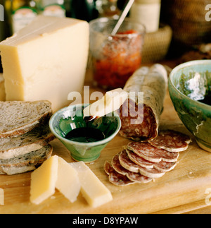Close up of salami, cheese  and bread on table Stock Photo