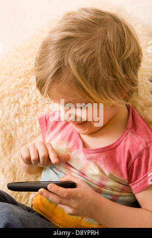 Boy playing with mobile phone Stock Photo