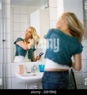 A woman brushing her hair. Stock Photo
