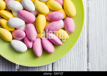 the sugared almonds on green plate Stock Photo