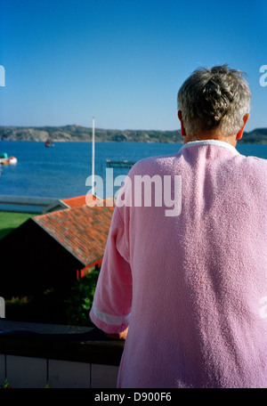 A man in a pink dressing gown, Gaso, Bohuslan, Sweden. Stock Photo