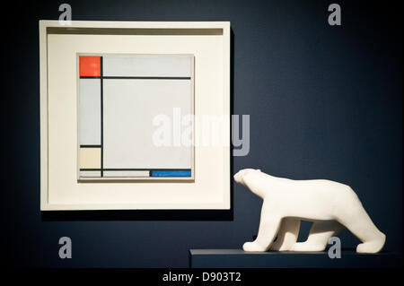 London, UK. 7th June 2013. a work by Piet Mondrian entitled “Composition with red, Yellow amd Blue, 1927) (Est. £4.5-6.5 million) stands next to a white marble sculpture by Francois Pompon during the preview of this summer auction estimated at £100 million. Credit:  Piero Cruciatti/Alamy Live News Stock Photo