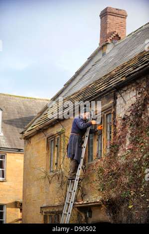 The village of Montacute in Somerset where residents can expect the country's highest life expectancy - an elderly man repairing Stock Photo