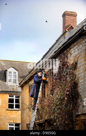 The village of Montacute in Somerset where residents can expect the country's highest life expectancy - an elderly man repairing Stock Photo