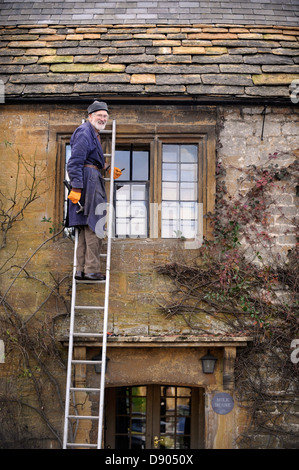 The village of Montacute in Somerset where residents can expect the country's highest life expectancy - an elderly man repairing Stock Photo