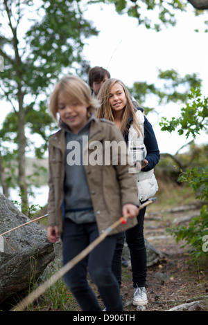 Father with two children walking along path Stock Photo