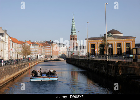 Tourist sightseeing boat on Gammel Strand canal with Nikolaj Kirke (Church) and Thorvaldsens museum on the background Copenhagen Stock Photo