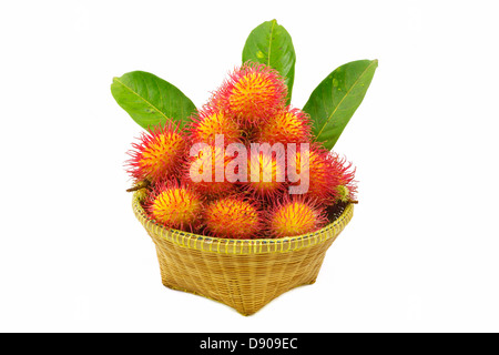 Organic rambutan Thai fruit in wicker basket isolated on white Stock Photo