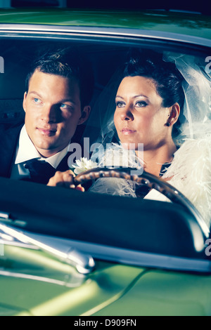 A bridal couple in a sports car, Sweden. Stock Photo