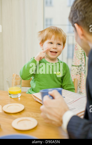 Father and son having breakfast, Sweden. Stock Photo