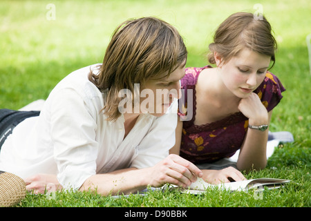 Young scandinavian couple reading a book together, Sweden. Stock Photo
