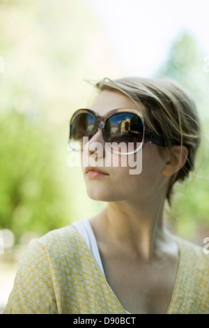 Portrait of a young scandinavian woman wearing sun glasses, Sweden. Stock Photo