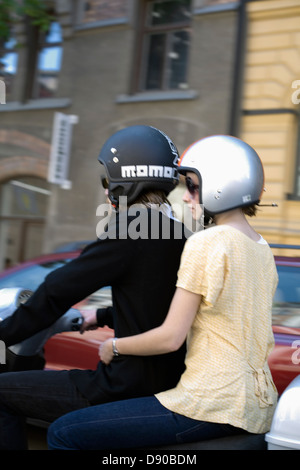 Young scandinavian couple riding a vespa, Sweden. Stock Photo