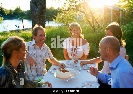 Five friends haveing a cake, Fejan, Stockholm archipelago, Sweden.