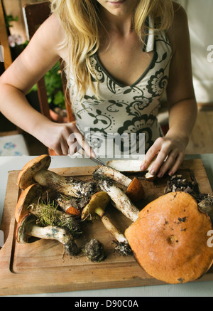 A girl cleaning mushrooms. Stock Photo