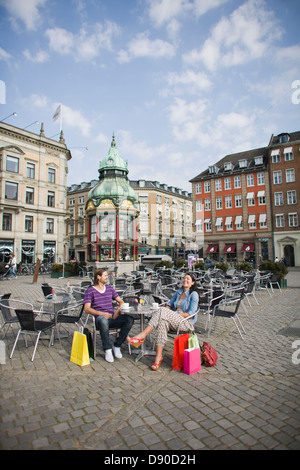 Couple sitting in pavement cafe, laughing Stock Photo