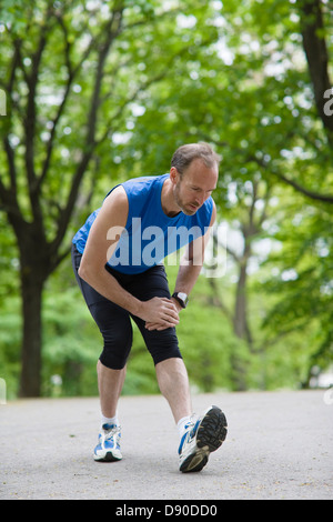 Man stretching in park Stock Photo