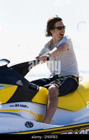 Smiling man riding a jet ski. Stock Photo