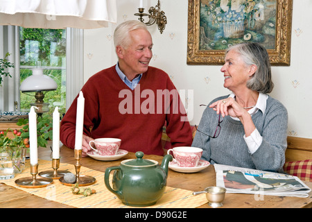 Senior couple at dining table having breakfast Stock Photo