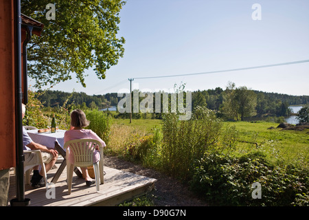 Senior couple sitting on porch Stock Photo