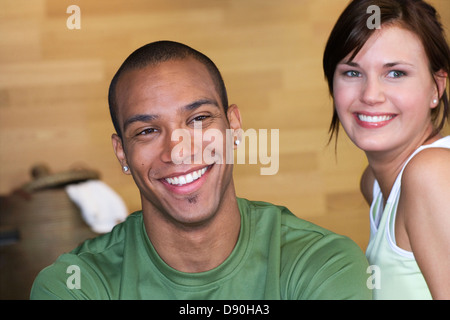 Smiling persons stretching in a gym. Stock Photo