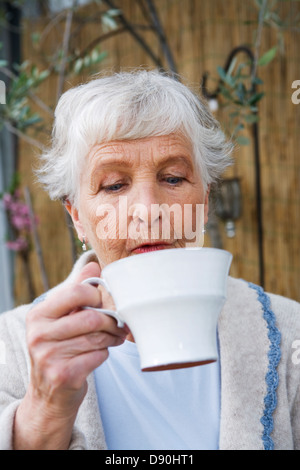 Woman drinking a cup of coffee. Stock Photo