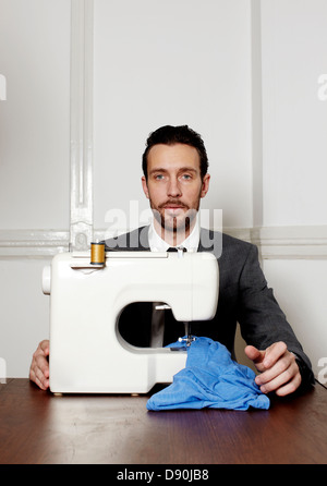 Man working on sewing machine Stock Photo