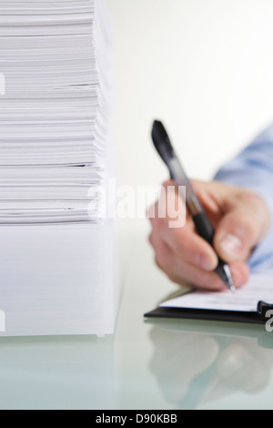 A hand writing on a paper. Stock Photo