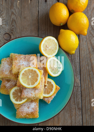 Plate with delicious lemon pie bars and cup of tea on table Stock Photo ...