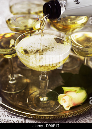 Champagne being poured into glass Stock Photo