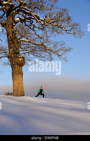 Mature woman stretching in winter Stock Photo