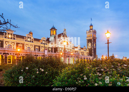 Dunedin Railway Station illuminated at twilight. Stock Photo