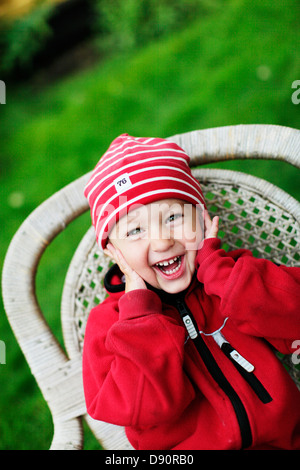 Girl sitting on a chair and smiling Stock Photo - Alamy