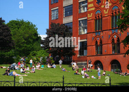 Glasgow, Scotland, UK. 7th June 2013. Glaswegians sunbathing in front of former Templeton Carpet Factory now Templeton on the Green Credit:  ALAN OLIVER/Alamy Live News Stock Photo