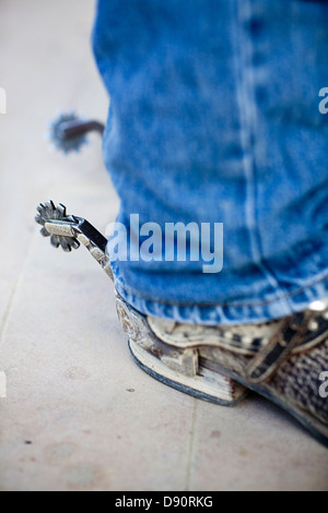 Low section of man wearing cowboy boots with spurs Stock Photo