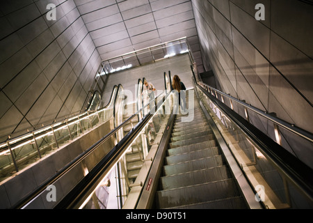 People on escalator in underground station Stock Photo