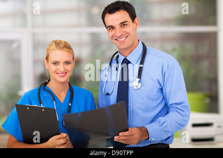 portrait of medical doctor and young female nurse in office Stock Photo