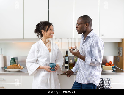 Smiling couple having breakfast in kitchen Stock Photo