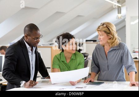 Coworkers having discussion in office Stock Photo