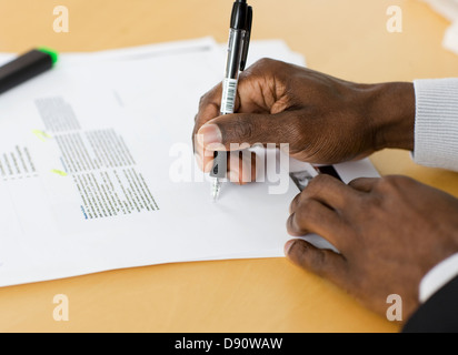Hands writing notes on document, close-up Stock Photo