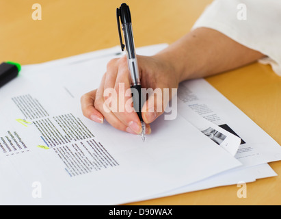 Hands writing notes on document, close-up Stock Photo