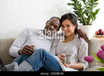 Couple sitting on sofa Stock Photo