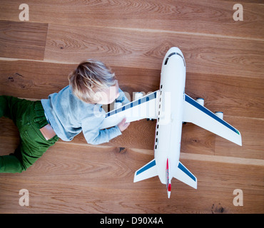 Boy playing with model airplane Stock Photo