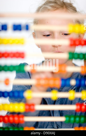 Girl behind colorful abacus Stock Photo