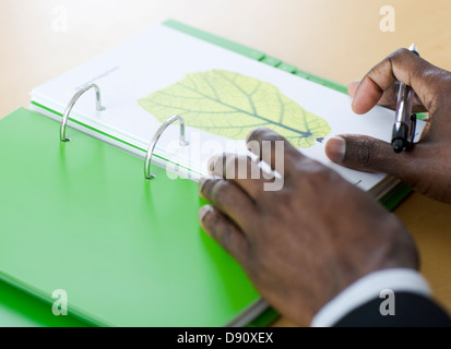 Close up of man''s hands on green notebook Stock Photo