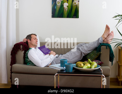 Mature man relaxing on sofa Stock Photo